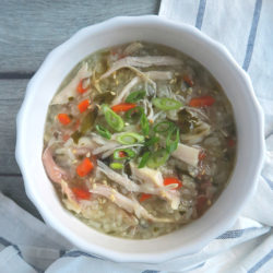 chicken veggies porridge in a white bowl.