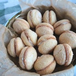 mini sponge cake sandwiches in a cookie tin.