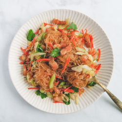 stir fry mung bean noodles with pork belly and vegetable on a plate..