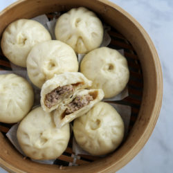 pork buns with sauerkraut in bamboo steamer.