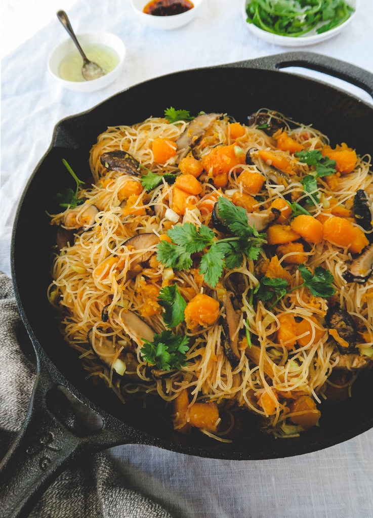 Cast iron skillet with butternut squash, rice noodles, and shitakke mushrooms.