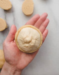 dough covered with cookie dough on a hand.