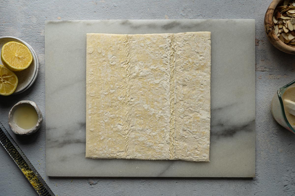 puff pastry sheet on a marble board. 