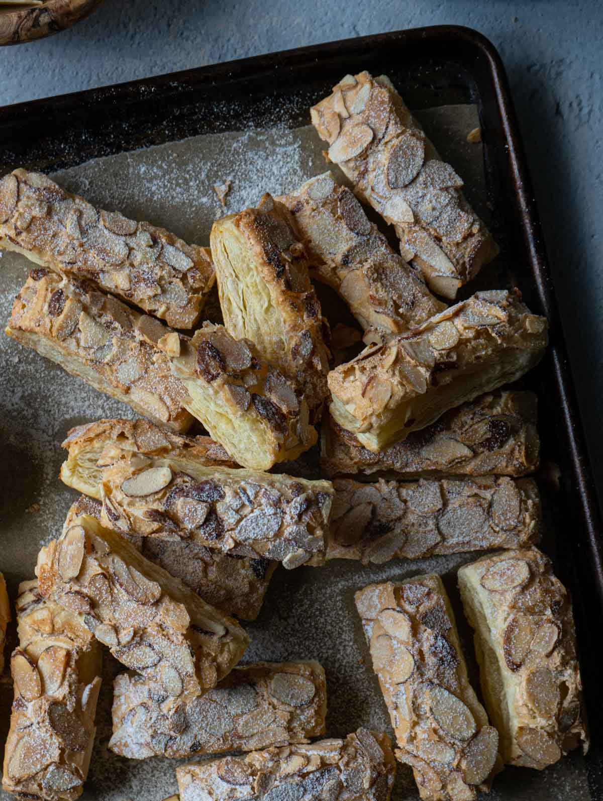 almond puff pastry cookies in a baking tray.