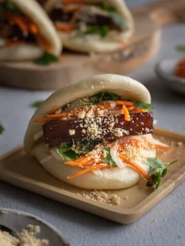Gua bao on a wooden plate.