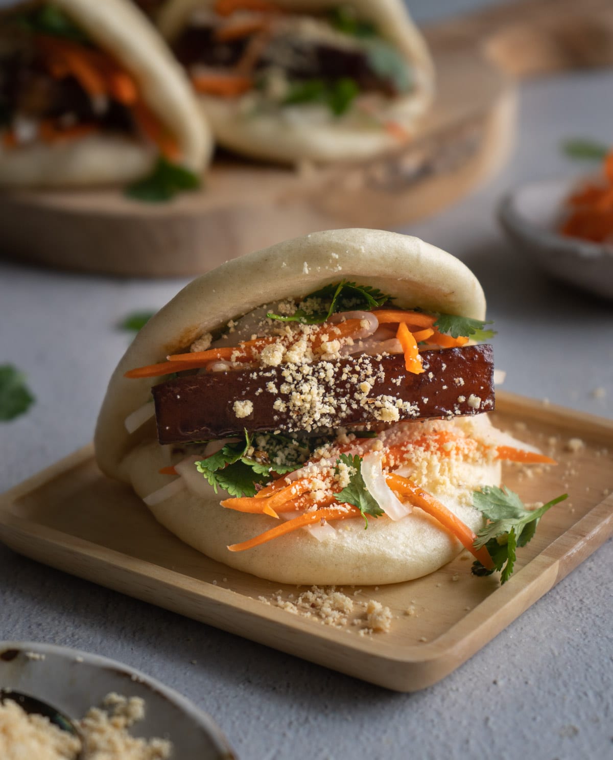 gua bao on a wood plate.