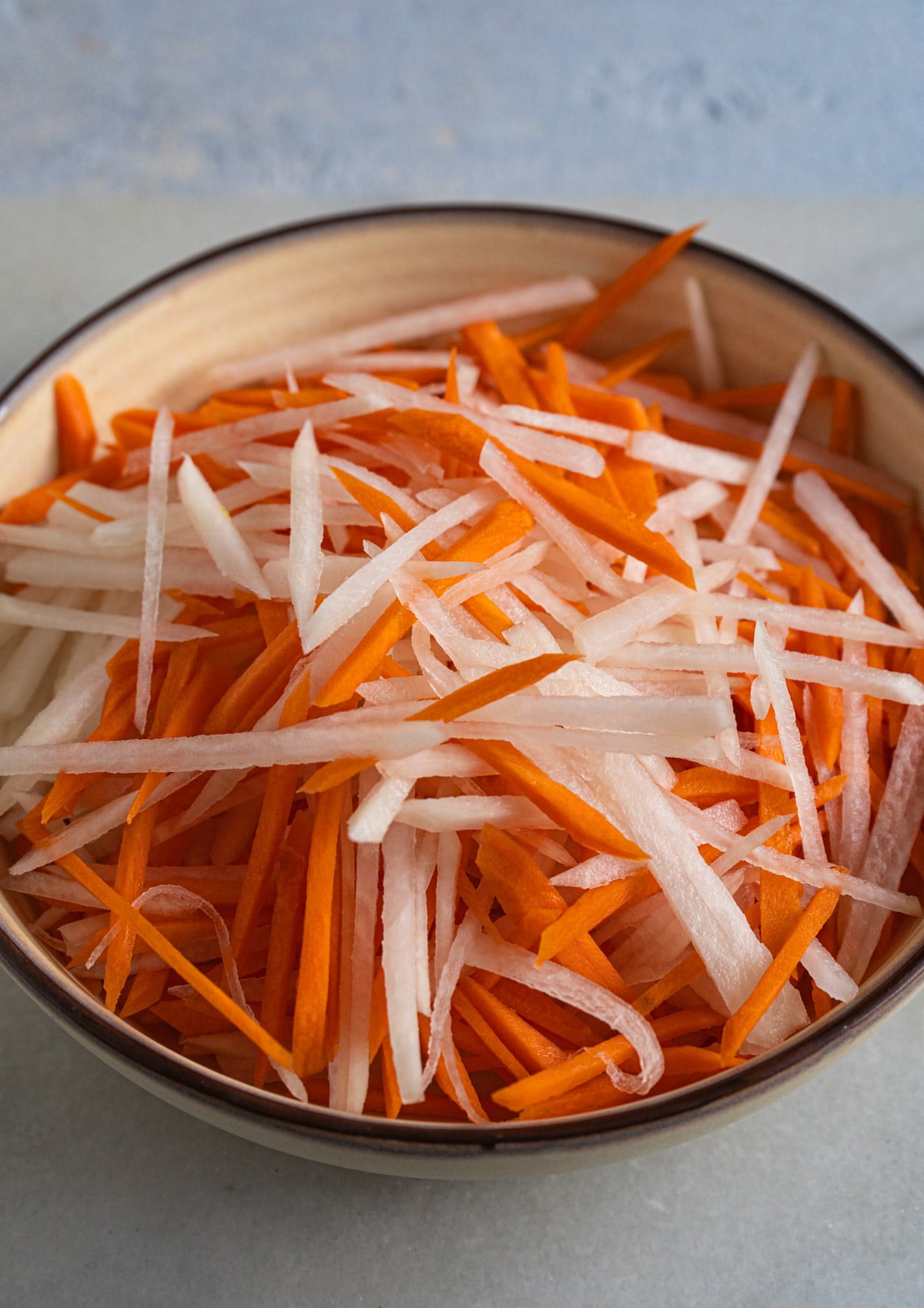 julienned carrots and daikon on a bowl, 