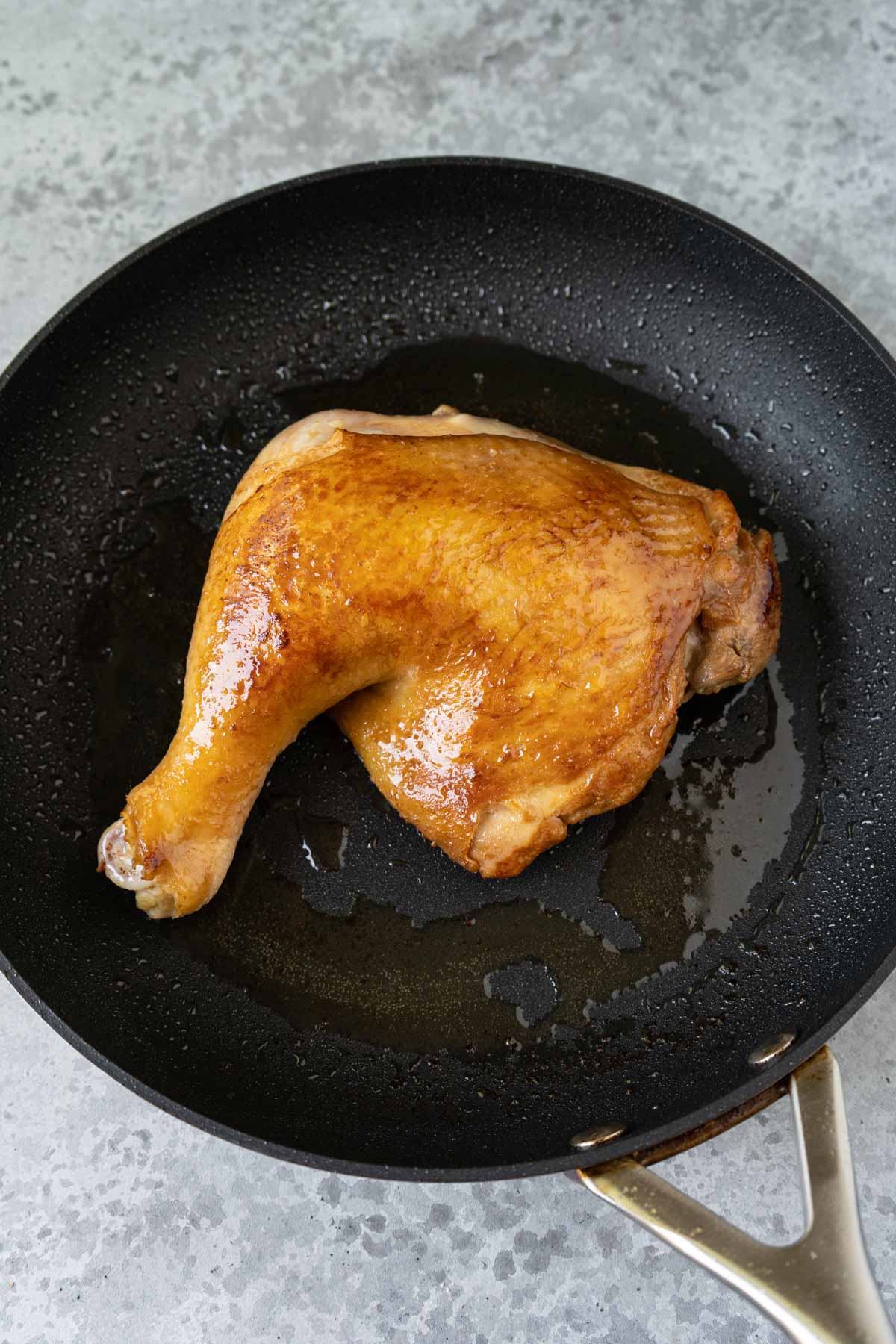 Pan fried chicken leg in a non stick skillet. 