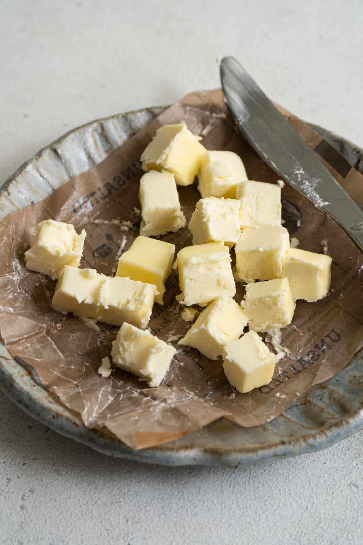 Butter cubes on a small plate. 