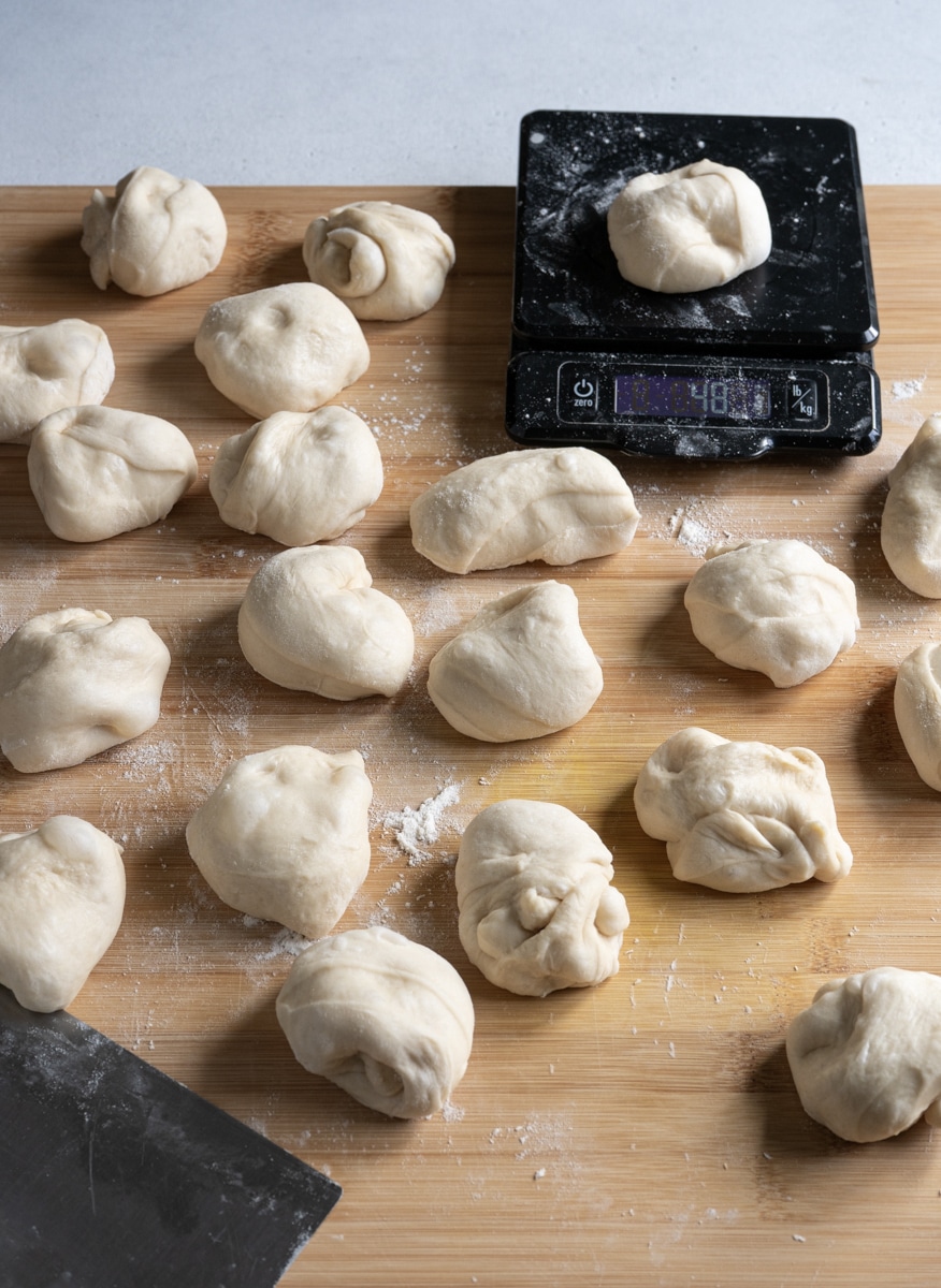 Small pieces of dough on a working surface with a scale on the side.
