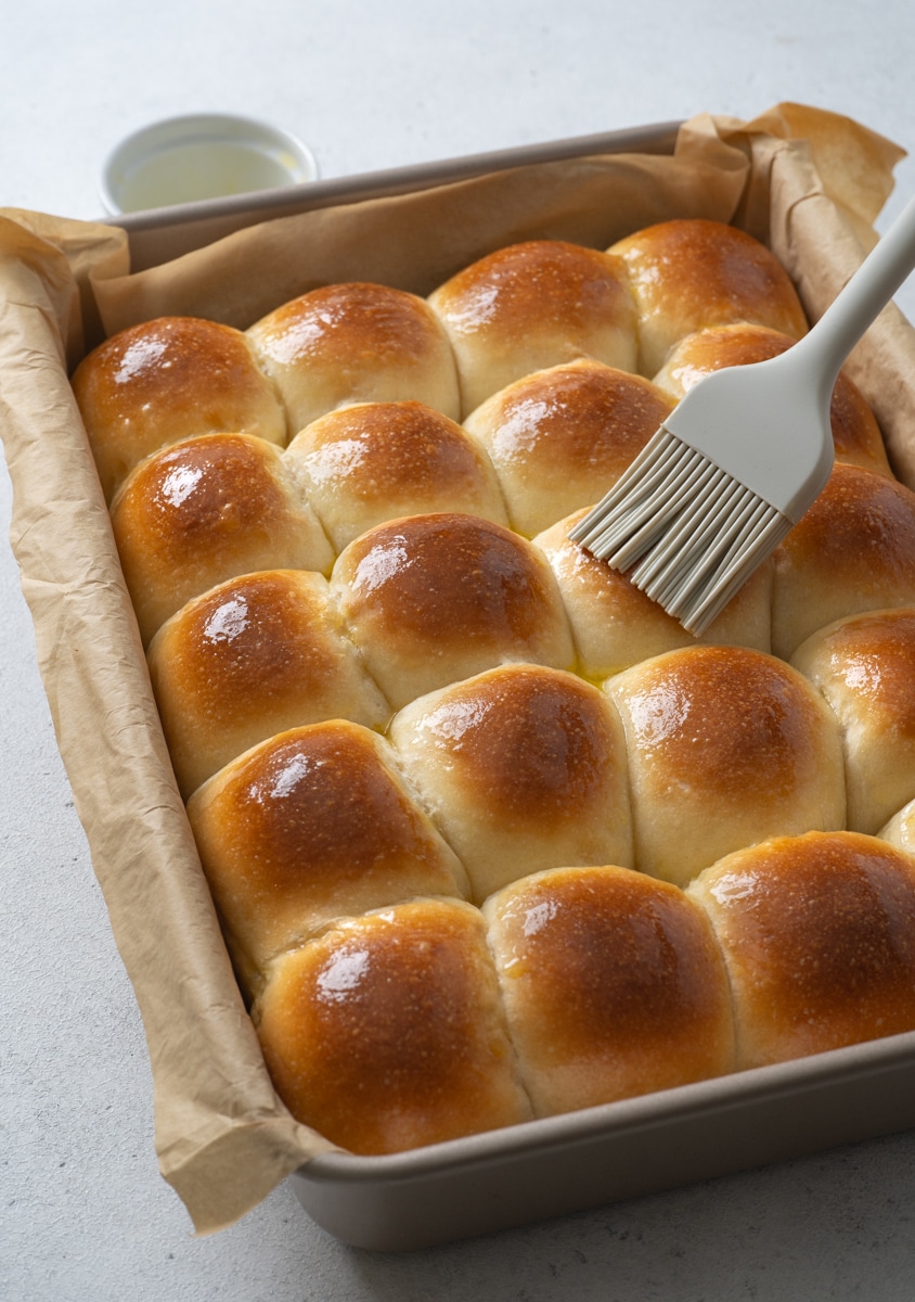 Freshly baked dinner rolls brushed with melted butter. 