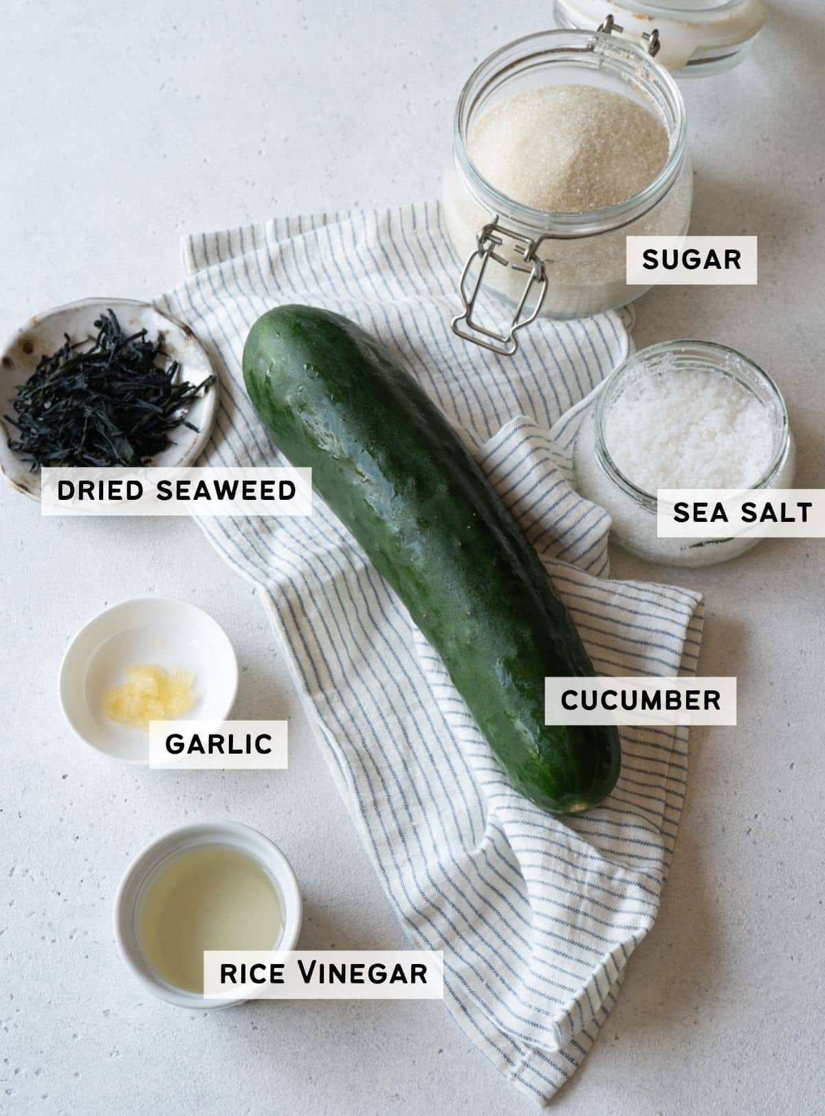 Labeled ingredients for cucumber and seaweed salad: cucumber, dried seaweed, sugar, sea salt, garlic, and rice vinegar."