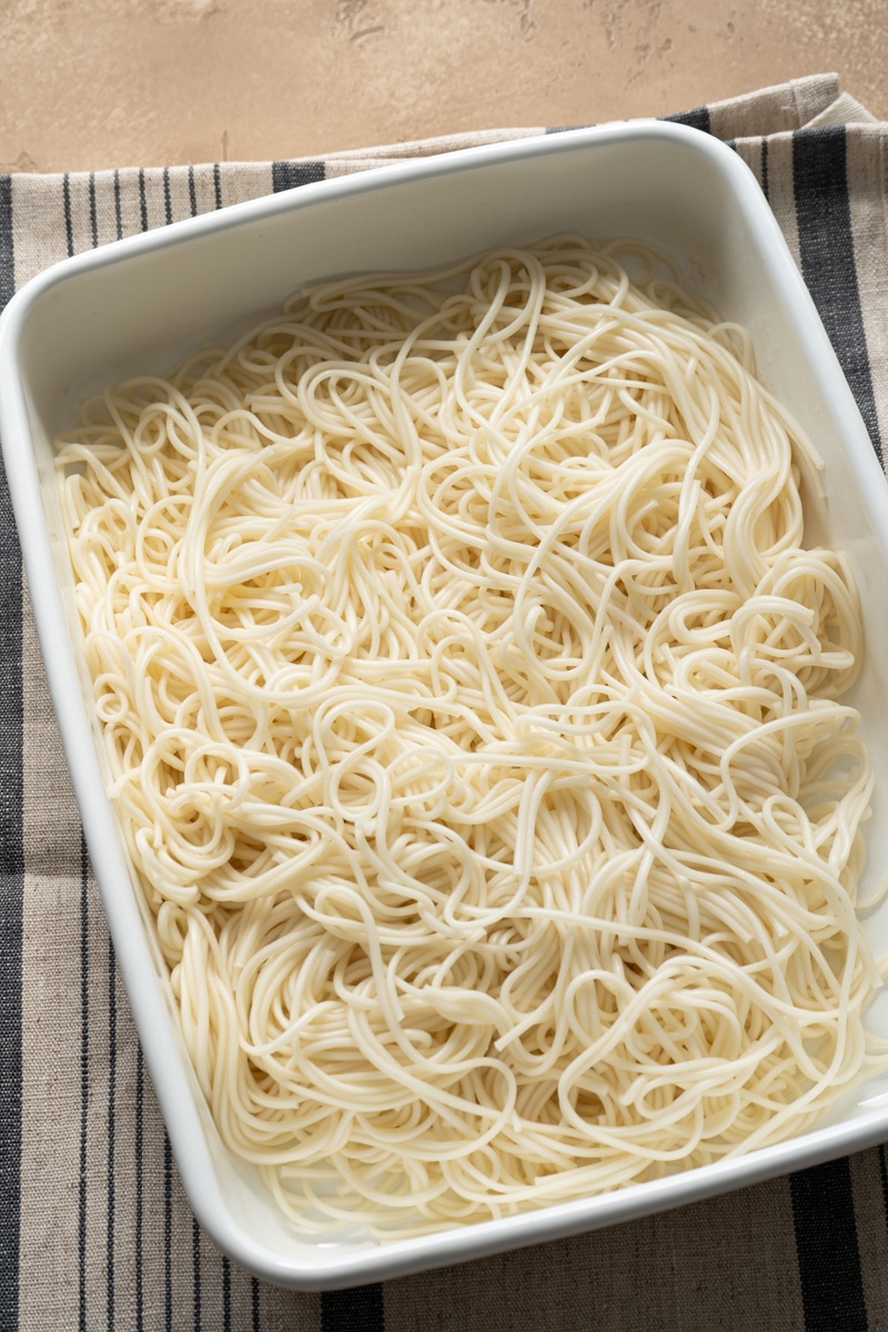 Cooked noodles in a white tray.
